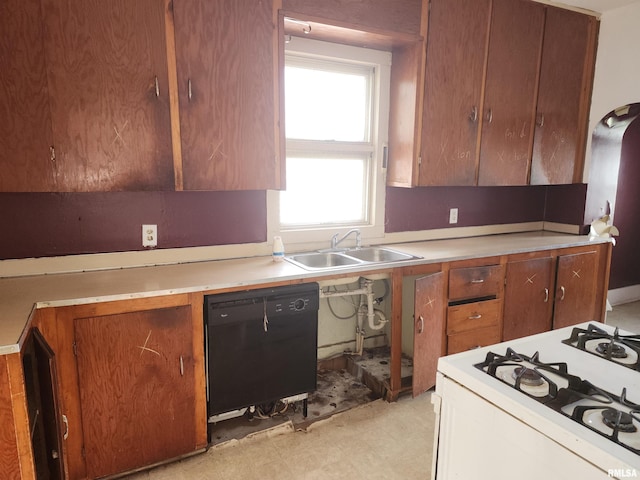 kitchen with range with gas stovetop, light floors, light countertops, a sink, and dishwasher