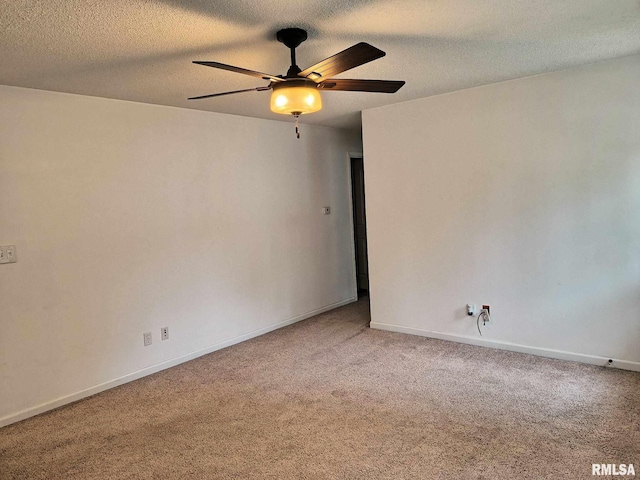 carpeted empty room featuring baseboards, a textured ceiling, and ceiling fan