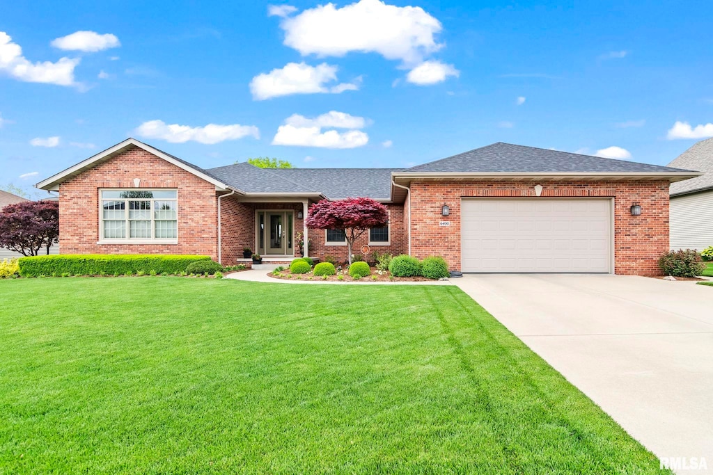 ranch-style home with an attached garage, brick siding, driveway, and a front lawn