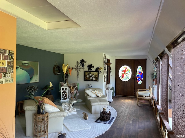 living room with a textured ceiling and wood finished floors