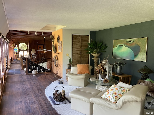 living area featuring a textured ceiling and wood finished floors