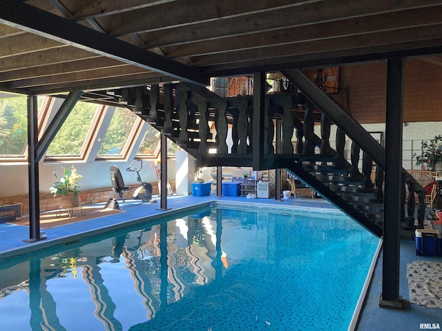 indoor pool featuring a skylight