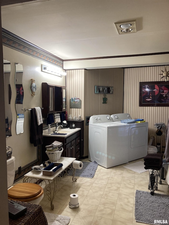 laundry room featuring washing machine and clothes dryer, laundry area, and a sink