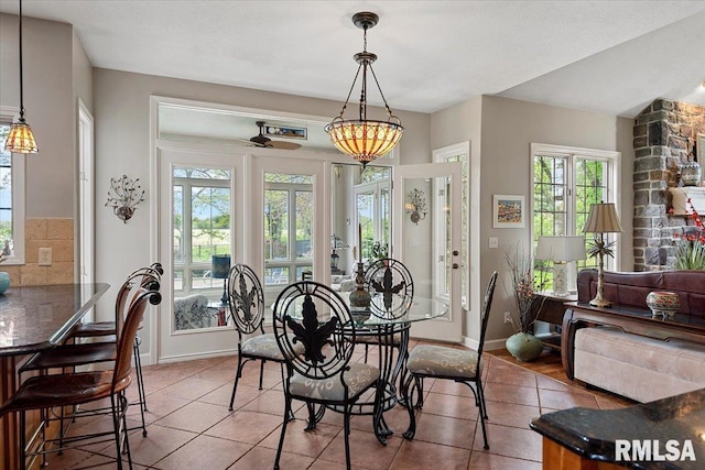 dining room with tile patterned floors and baseboards