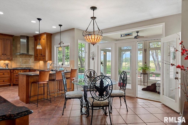 dining room featuring light tile patterned flooring, a textured ceiling, french doors, and recessed lighting