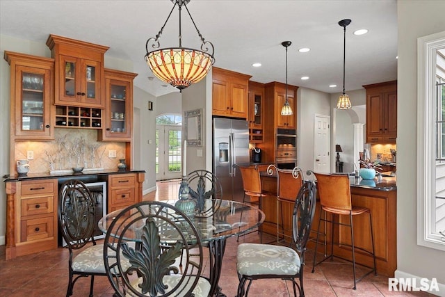 tiled dining area with beverage cooler, baseboards, and recessed lighting