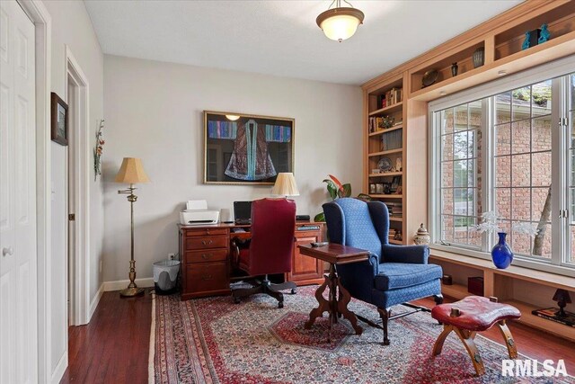 office area with dark wood finished floors and baseboards
