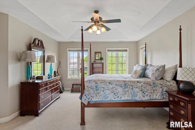 bedroom featuring light carpet, baseboards, and a ceiling fan