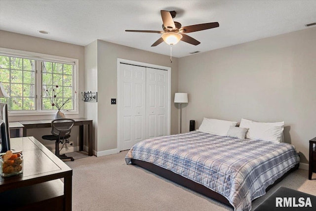 bedroom featuring carpet, a closet, baseboards, and visible vents