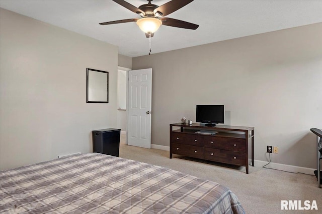 bedroom with baseboards, a ceiling fan, and carpet