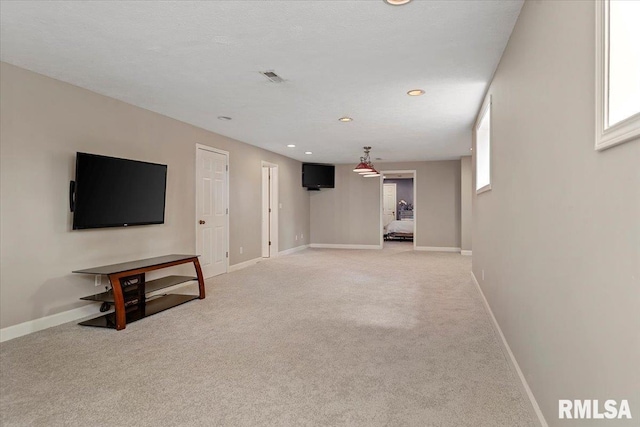below grade area featuring light colored carpet, baseboards, visible vents, and recessed lighting
