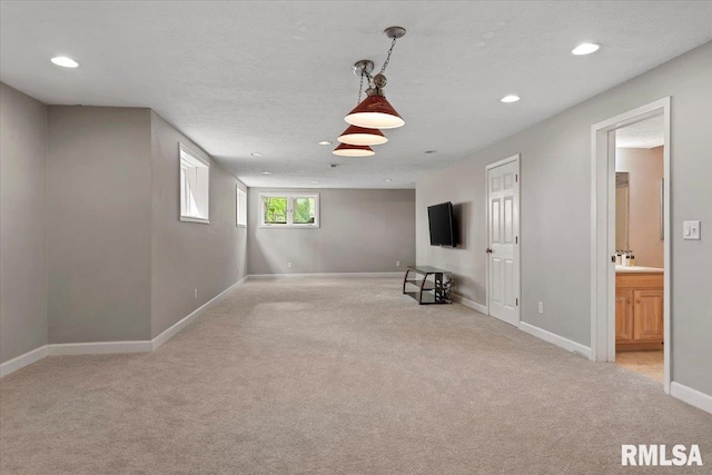 interior space with light carpet, baseboards, and recessed lighting