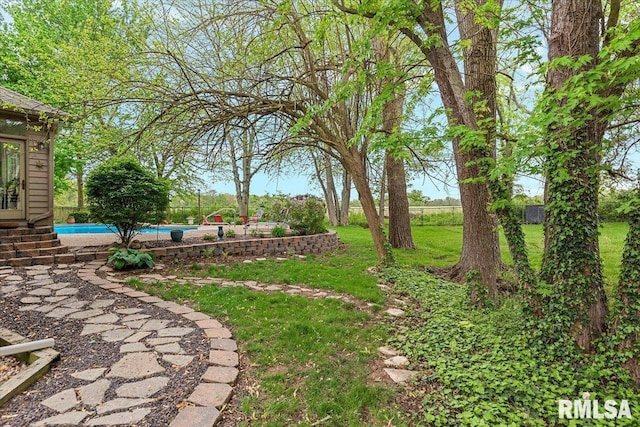 view of yard featuring an outdoor pool