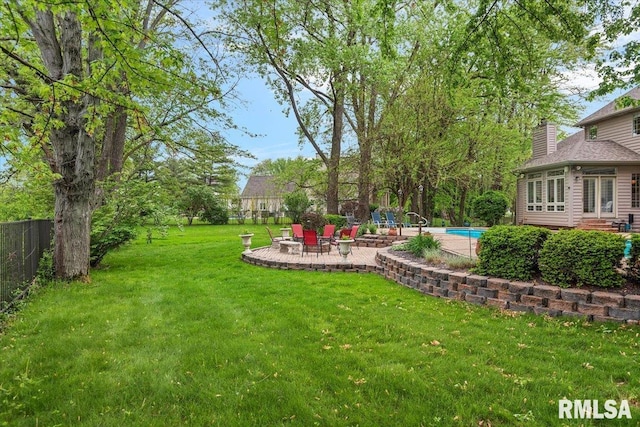 view of yard featuring a patio area, an outdoor pool, and fence