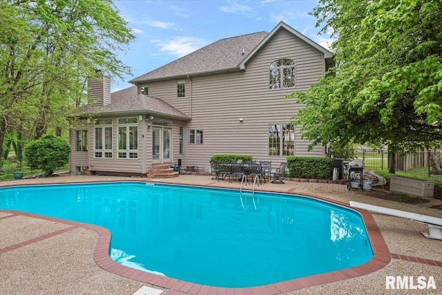 view of swimming pool with a patio area, fence, entry steps, a fenced in pool, and a sunroom