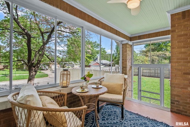 sunroom / solarium featuring ceiling fan