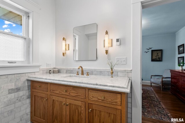 bathroom featuring vanity, tile walls, a wainscoted wall, and wood finished floors