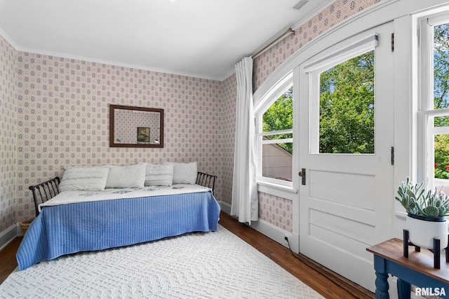 bedroom featuring wallpapered walls, wood finished floors, and ornamental molding