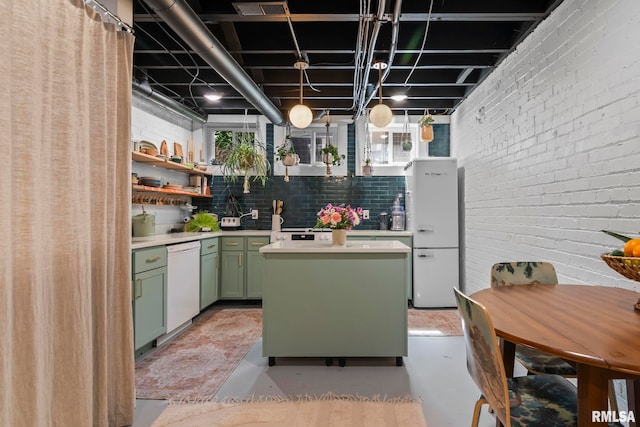 kitchen featuring open shelves, green cabinetry, white appliances, light countertops, and a kitchen island