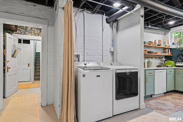 washroom with washer and clothes dryer and laundry area