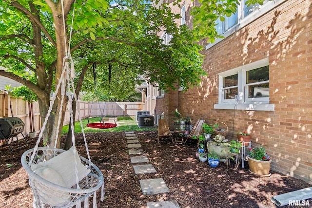 view of yard with central AC unit and a fenced backyard