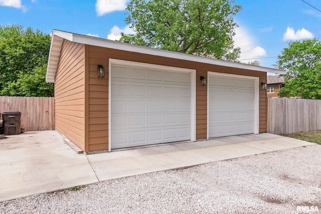 detached garage featuring fence