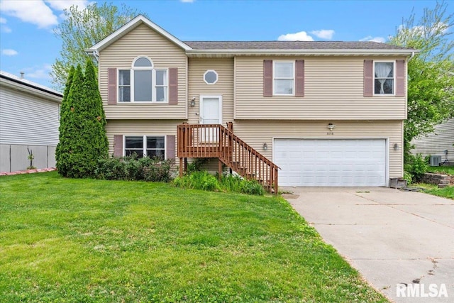 split foyer home with a front yard, driveway, a garage, and central air condition unit