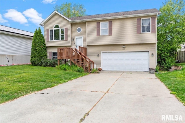split foyer home with a front lawn, concrete driveway, and a garage