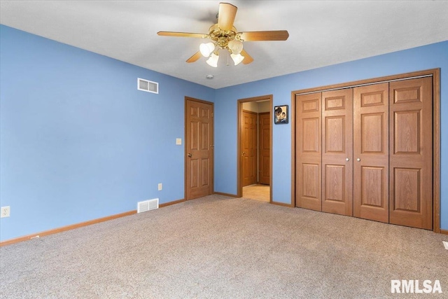 unfurnished bedroom with carpet floors, baseboards, and visible vents