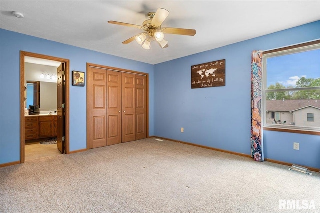 unfurnished bedroom featuring ensuite bathroom, carpet floors, a closet, and baseboards