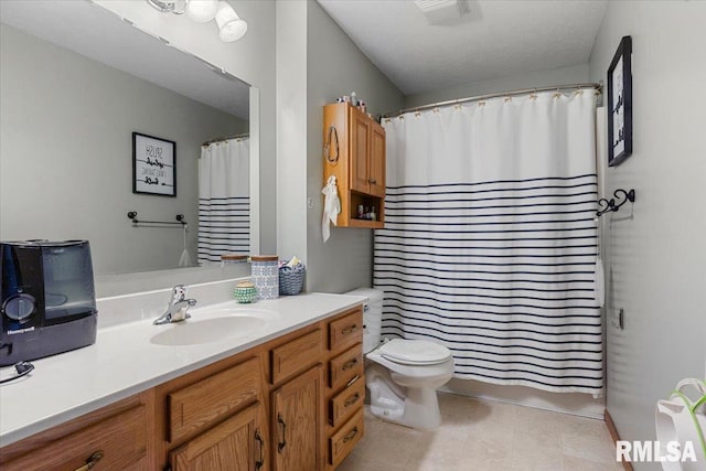 full bathroom featuring toilet, tile patterned flooring, vanity, and visible vents