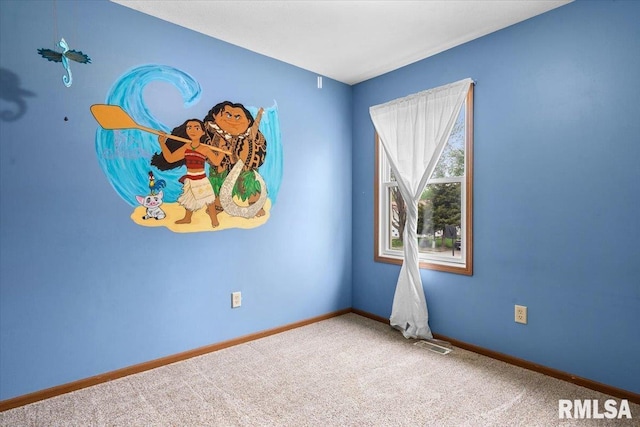 spare room featuring carpet floors, baseboards, and visible vents