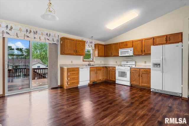kitchen with a sink, dark wood-type flooring, white appliances, light countertops, and vaulted ceiling