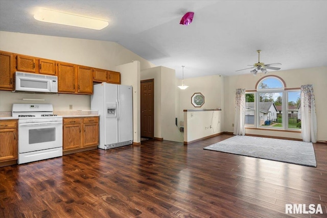 kitchen featuring brown cabinetry, white appliances, light countertops, and vaulted ceiling