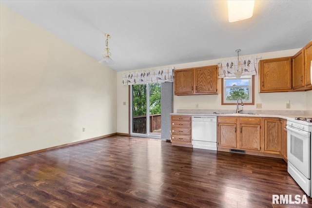 kitchen featuring a sink, white appliances, visible vents, dark wood finished floors, and light countertops
