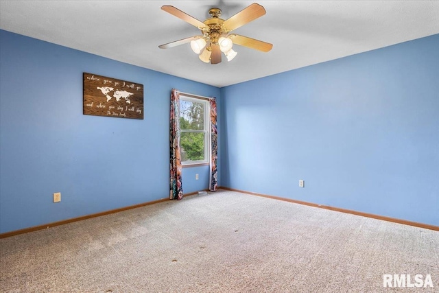 empty room featuring baseboards, a ceiling fan, and carpet floors