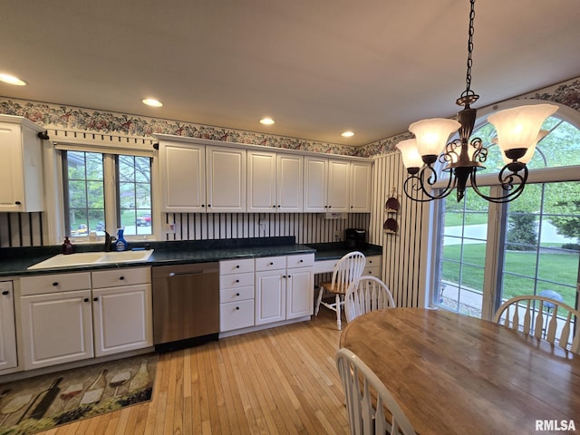 2704 Kings Pointe NE Unit 2704, Quincy, IL 62305 - kitchen featuring light wood finished floors, a sink, dark countertops, stainless steel dishwasher, and a chandelier