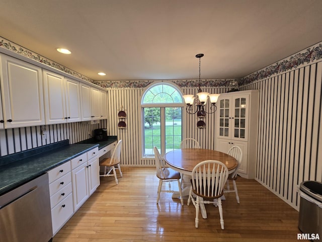 2704 Kings Pointe NE Unit 2704, Quincy, IL 62305 - dining space featuring baseboards, light wood-style floors, an inviting chandelier, and wallpapered walls