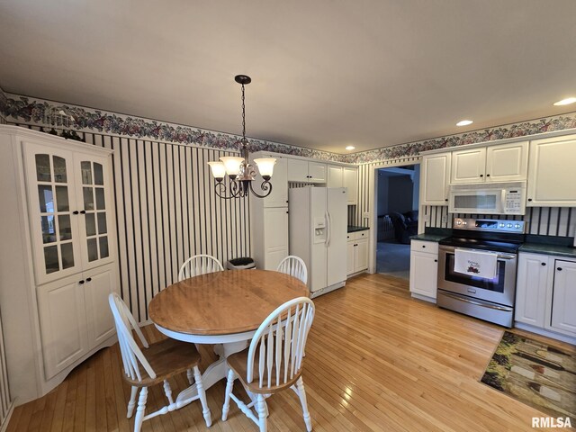 2704 Kings Pointe NE Unit 2704, Quincy, IL 62305 - dining space with an inviting chandelier, light wood-type flooring, wallpapered walls, and recessed lighting