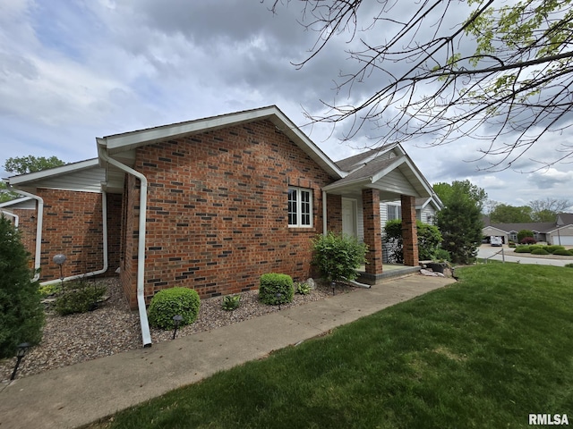 2704 Kings Pointe NE Unit 2704, Quincy, IL 62305 - view of side of property featuring a yard and brick siding