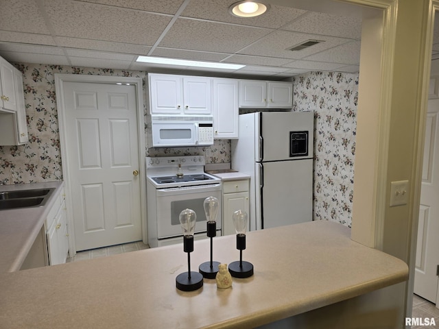 2704 Kings Pointe NE Unit 2704, Quincy, IL 62305 - kitchen featuring light tile patterned floors, white appliances, visible vents, and wallpapered walls