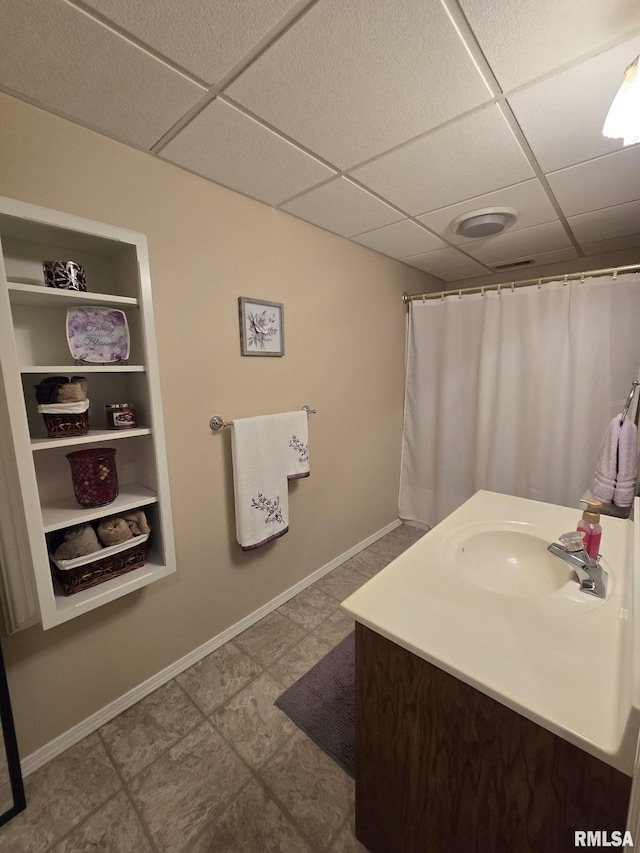 2704 Kings Pointe NE Unit 2704, Quincy, IL 62305 - bathroom featuring a paneled ceiling, vanity, baseboards, and built in features