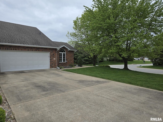 2704 Kings Pointe NE Unit 2704, Quincy, IL 62305 - ranch-style home featuring driveway, brick siding, a garage, a shingled roof, and a front yard
