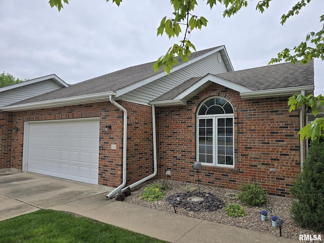 2704 Kings Pointe NE Unit 2704, Quincy, IL 62305 - view of side of home featuring driveway, a shingled roof, brick siding, and a garage