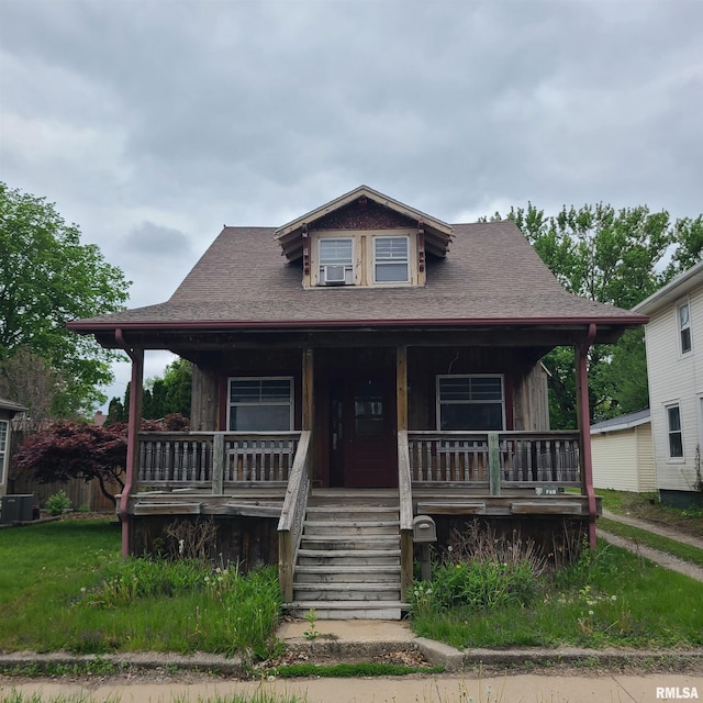 207 W Main St, Knoxville, IL 61448 - view of front of home with covered porch, central AC, cooling unit, a shingled roof, and stairs