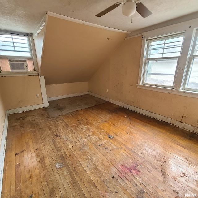 207 W Main St, Knoxville, IL 61448 - additional living space featuring hardwood / wood-style flooring, vaulted ceiling, ceiling fan, cooling unit, and baseboards