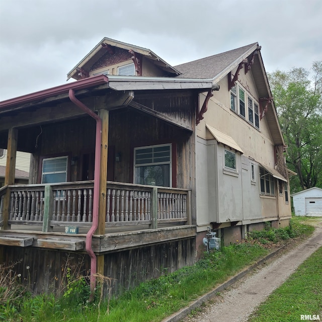 207 W Main St, Knoxville, IL 61448 - view of side of property featuring covered porch and a garage