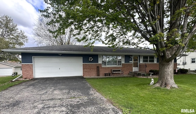 ranch-style house with a front yard, brick siding, a garage, and aphalt driveway