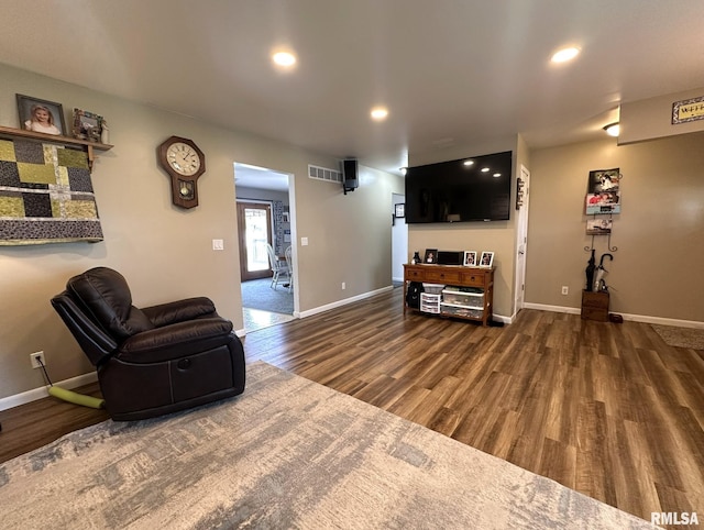 living area with baseboards, recessed lighting, visible vents, and wood finished floors