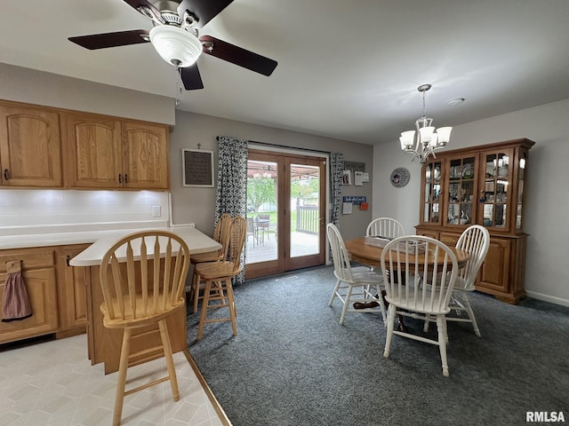 dining space with light colored carpet, french doors, and ceiling fan with notable chandelier